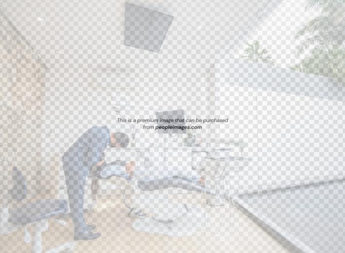 Dentist examining a patient in a modern dental clinic.